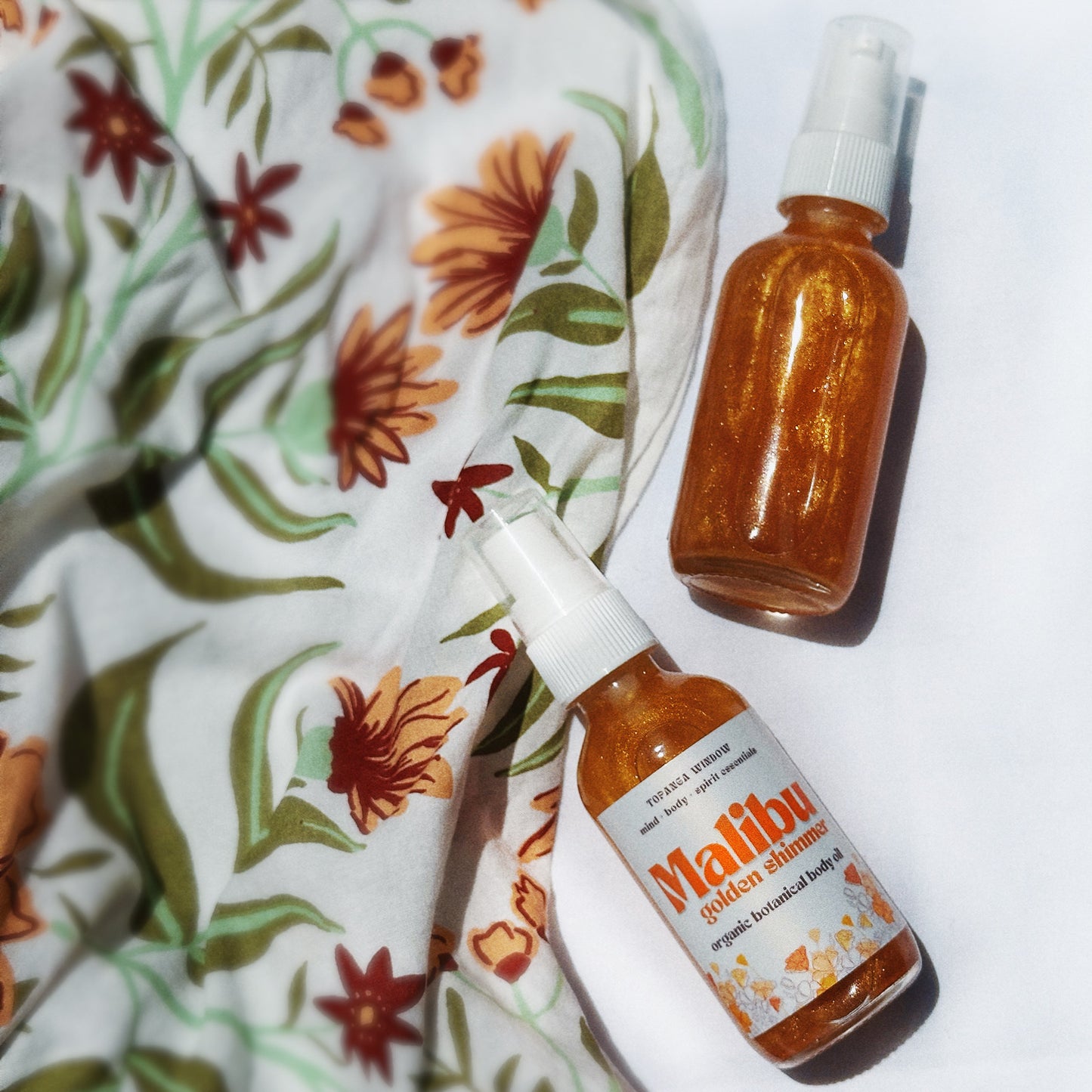Gold shimmer body oil with orange glow