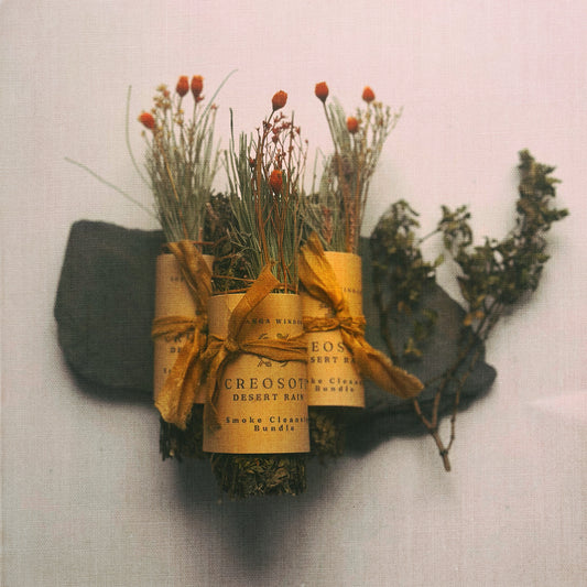 creosote bundle with twine packaging on a textured surface