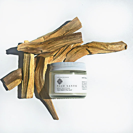 Palo Santo incense sticks and a container of Palo Santo resin butter on a white background