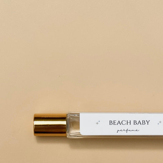 beach perfume  roll on bottle. yellow background glass bottle with gold top