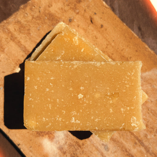 Block of yellowish soap on a brown surface