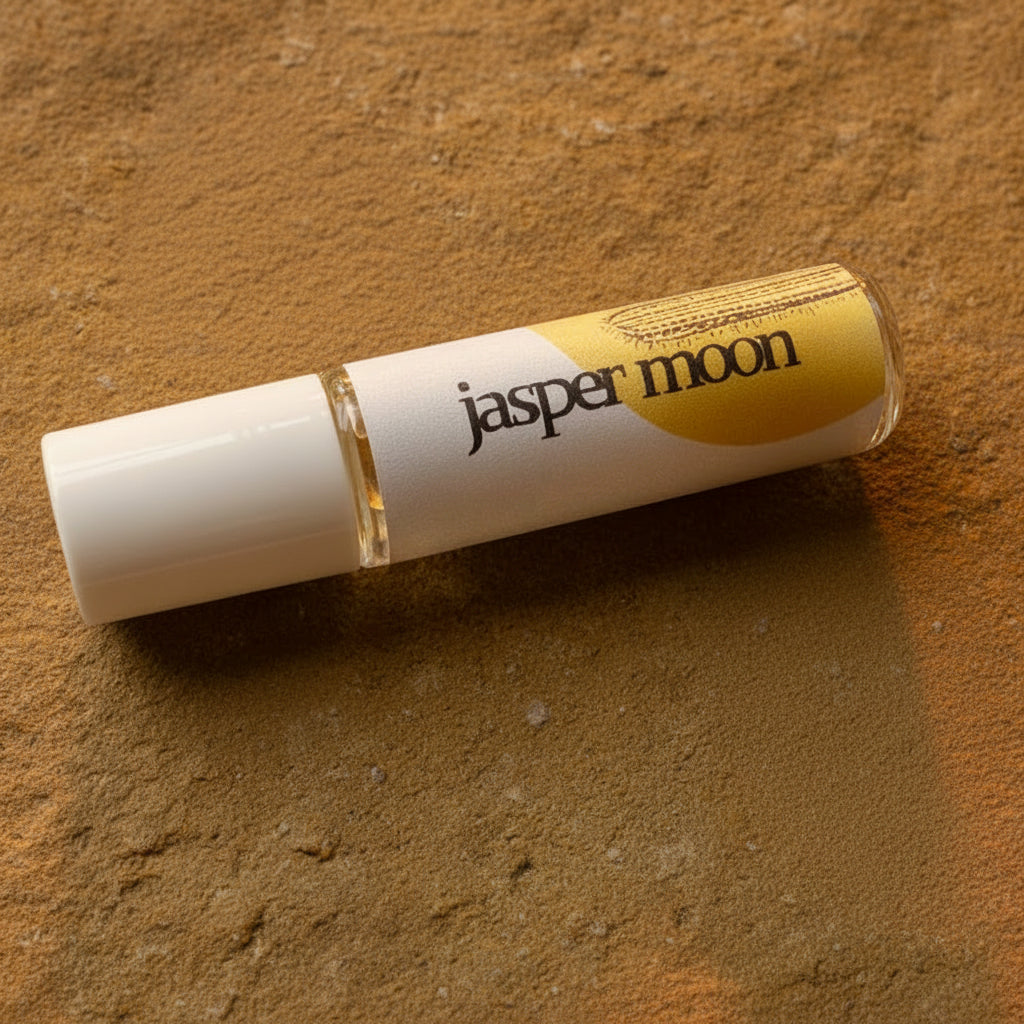 Roll-up product with 'jasper moon' branding on a beige stone surface