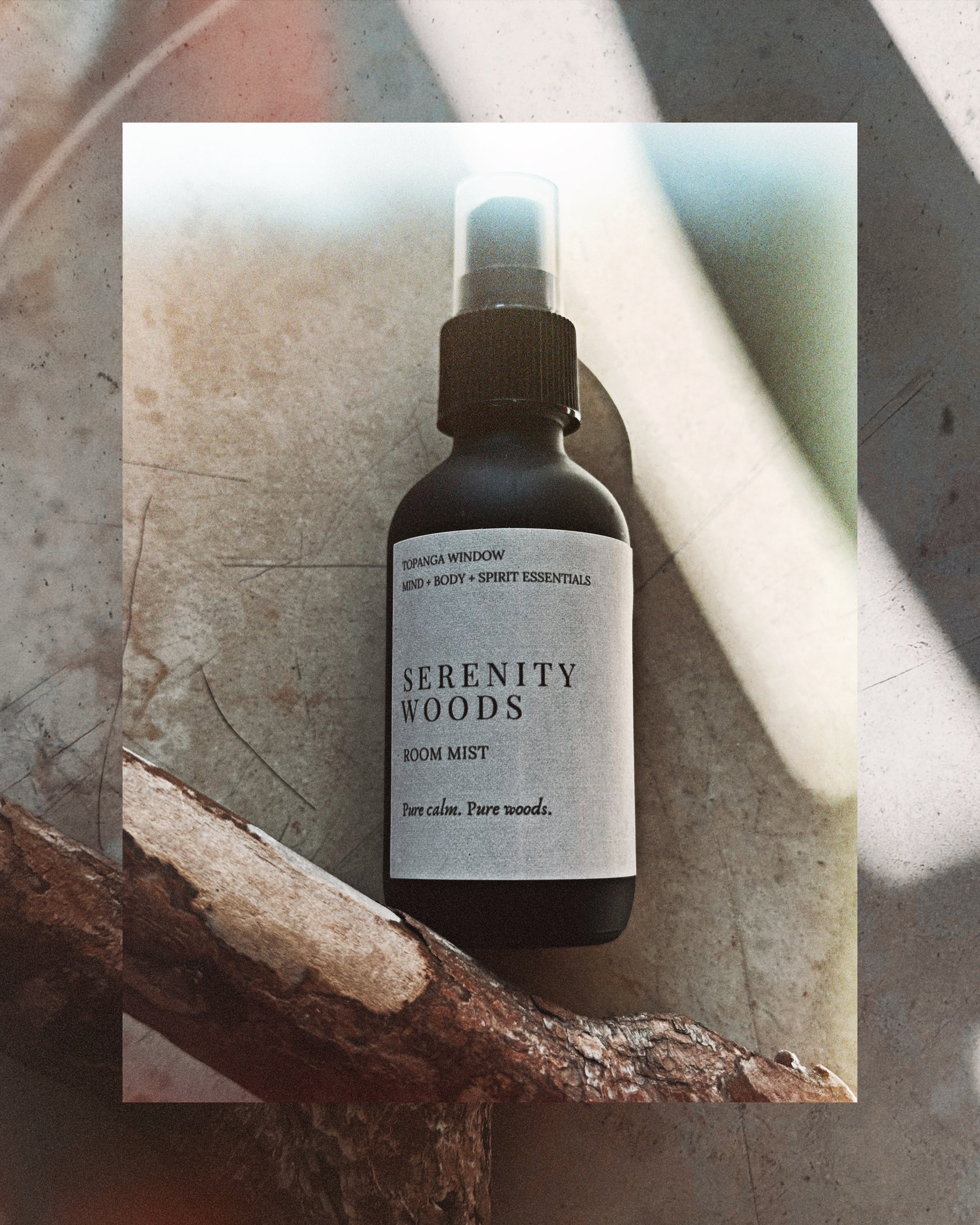 Serenity Woods room mist bottle on a textured surface