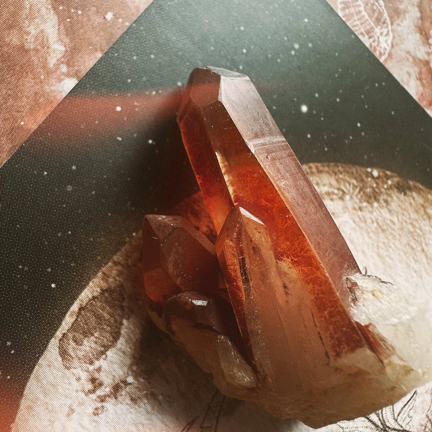 A polished tangerine quartz crystal cluster with a reflective orange hue, placed on a textured background with abstract patterns.