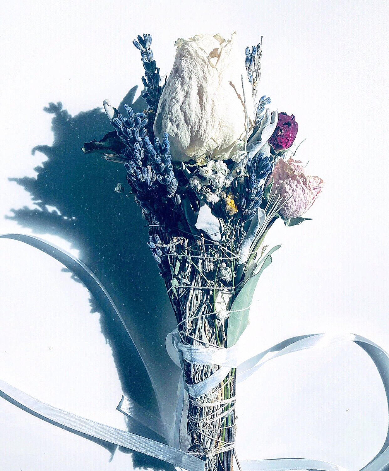 beautiful spiritual smoke stick made for smudging and energy  cleansing. Made with a large white rose, lavender, daisies, pink miniature roses and eucalyptus. 