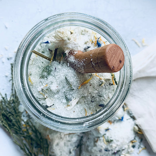 natural organic herbal bath salts with wooden spoon glass jar